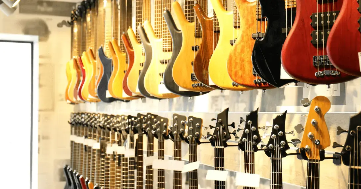 A wall of hanging electric guitars