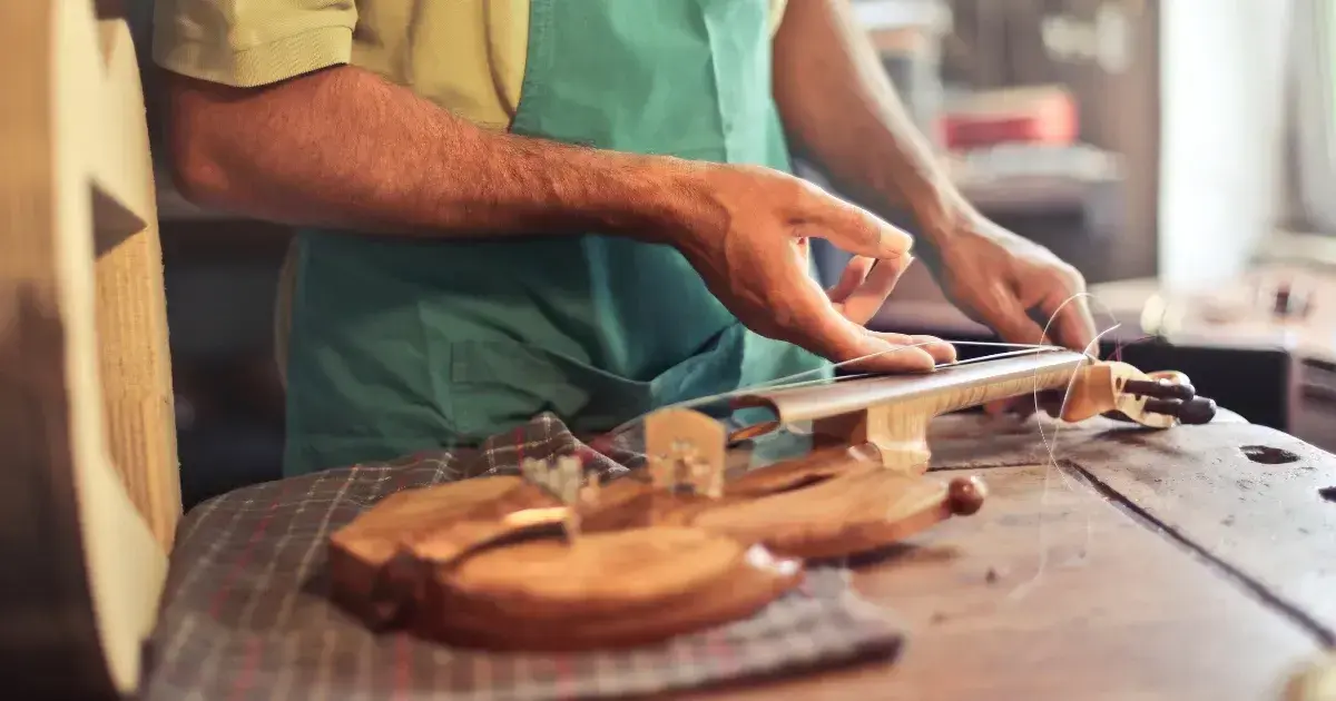 man repairing a guitar