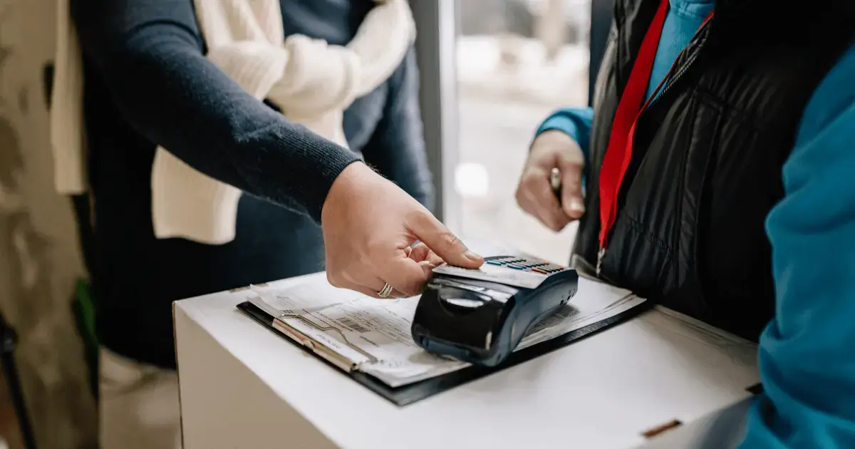 person paying with a card at a payment terminal